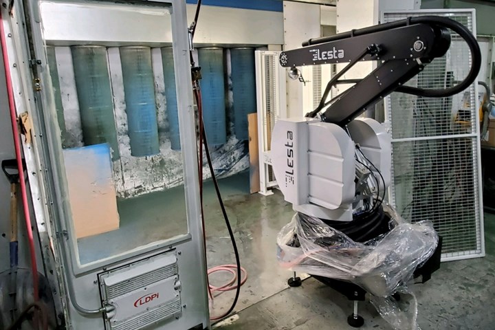 Photo of robot spraying pain onto racks of parts