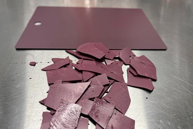 Photo of dark pink chips of hardened, recycled powder coating