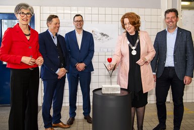 Mayor of Teylingen, Carla Breuer, is pictured with a symbolic powder-coated tulip during a ceremony held inside the building that will become the new powder technology center.