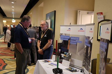 attendees visiting table top exhibits