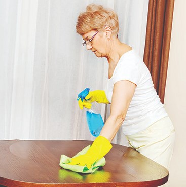 woman cleaning table
