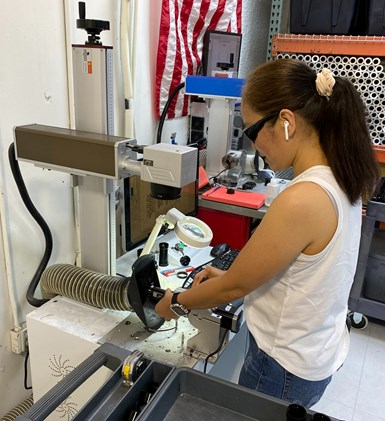 woman working on laser marking system on shop floor