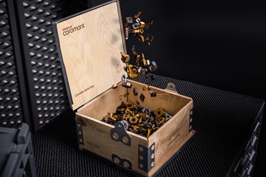 A wooden box with cutting inserts falling into it