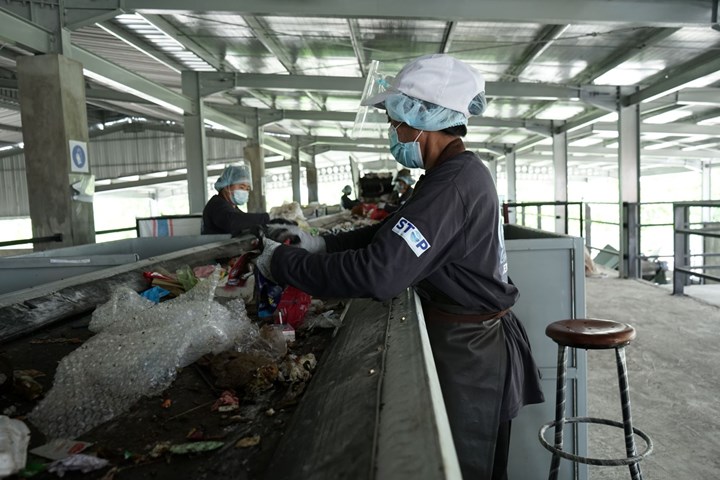 Trabajadores del proyecto STOP en una línea de clasificación de residuos en Jembrana, Indonesia.