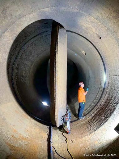Photo of man inside 180-in. pipe inspecting body seat ring in a butterfly valve.