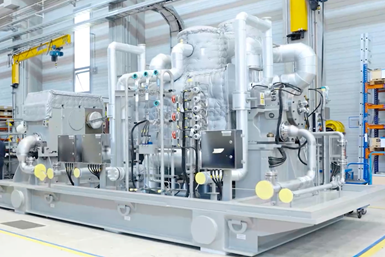 Image of Oklo's industrial steam turbine package installed in plant.
