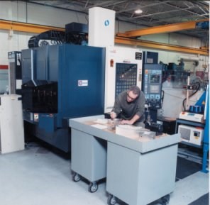 A machinist making and measuring molds.