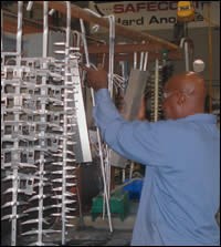 An operator readies racked parts