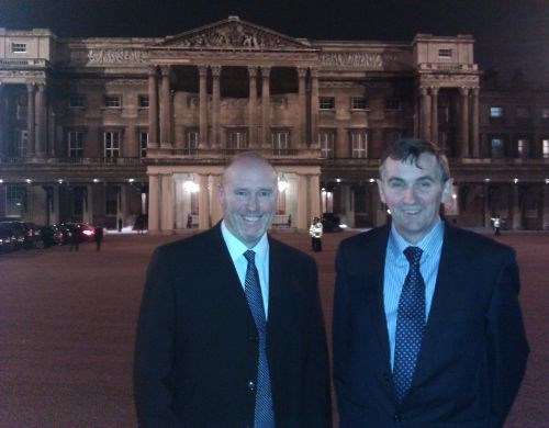 Andy Butter and Pete Hajdukiewicz stand outside Buckingham Palace on the night of the awards reception.